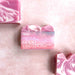 Bar of soap with 'Good Vibrations' text on a pink background
