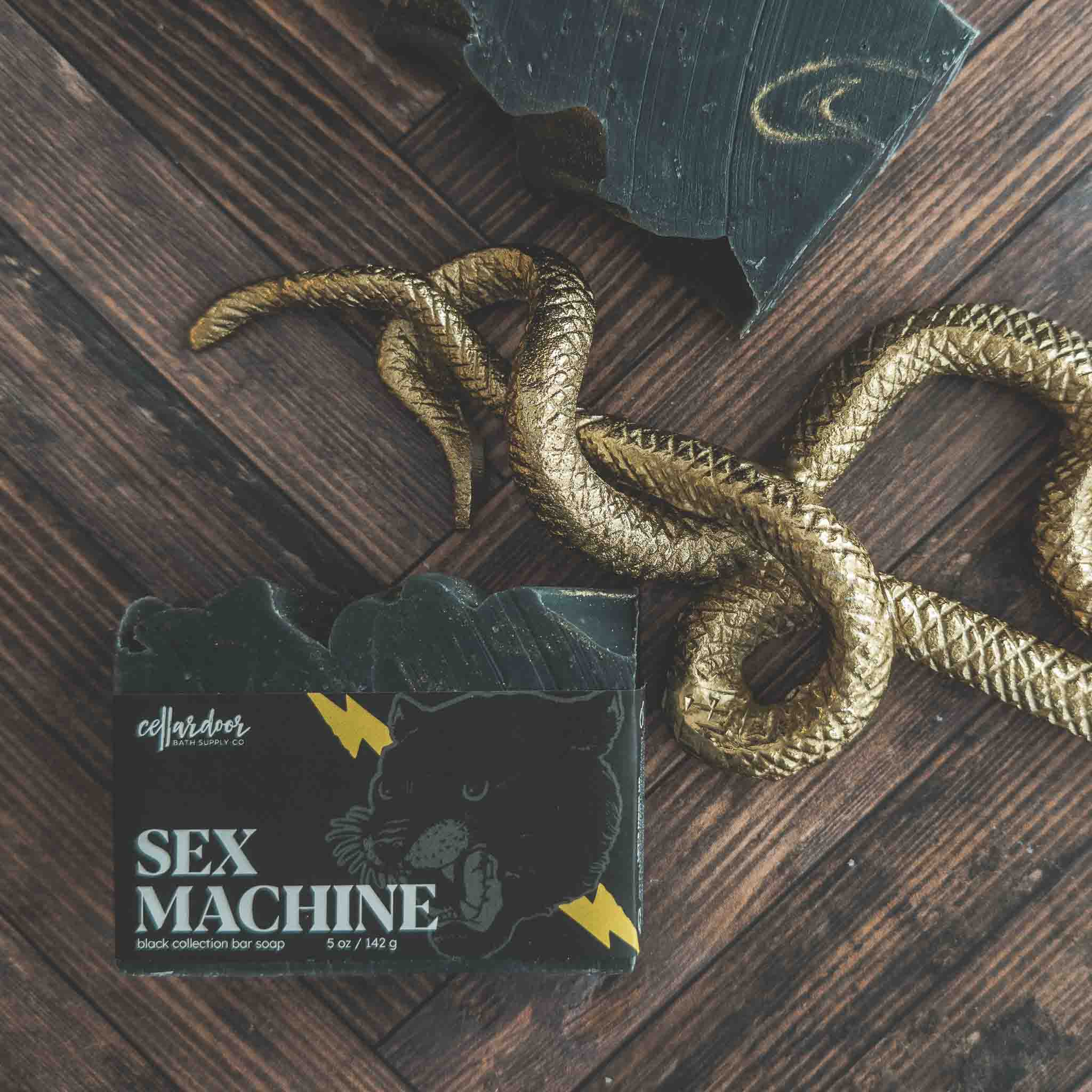 Soap bar labeled 'Sex Machine' with a snake on a wooden surface