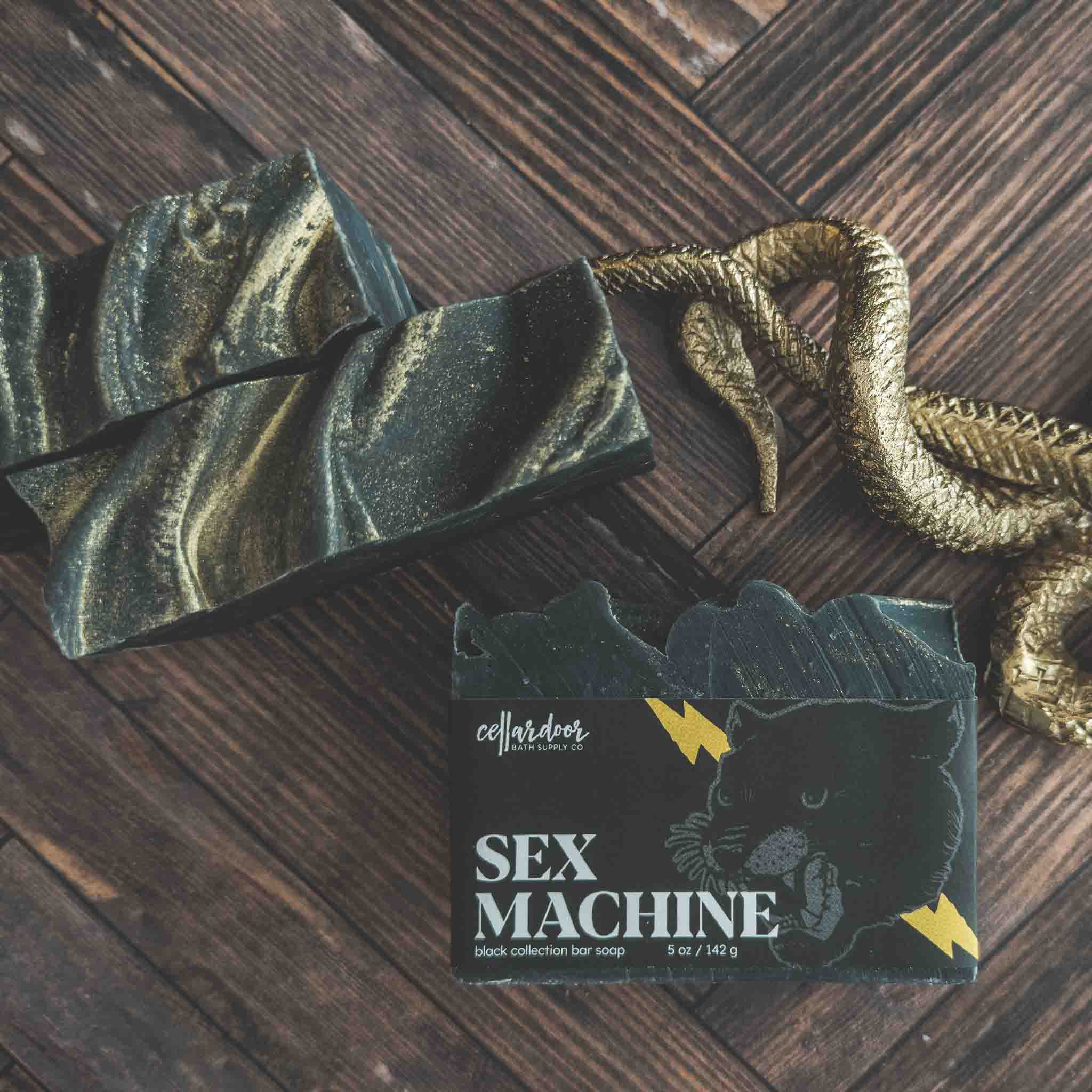 Bar of soap with packaging labeled 'Sex Machine' on a wooden surface