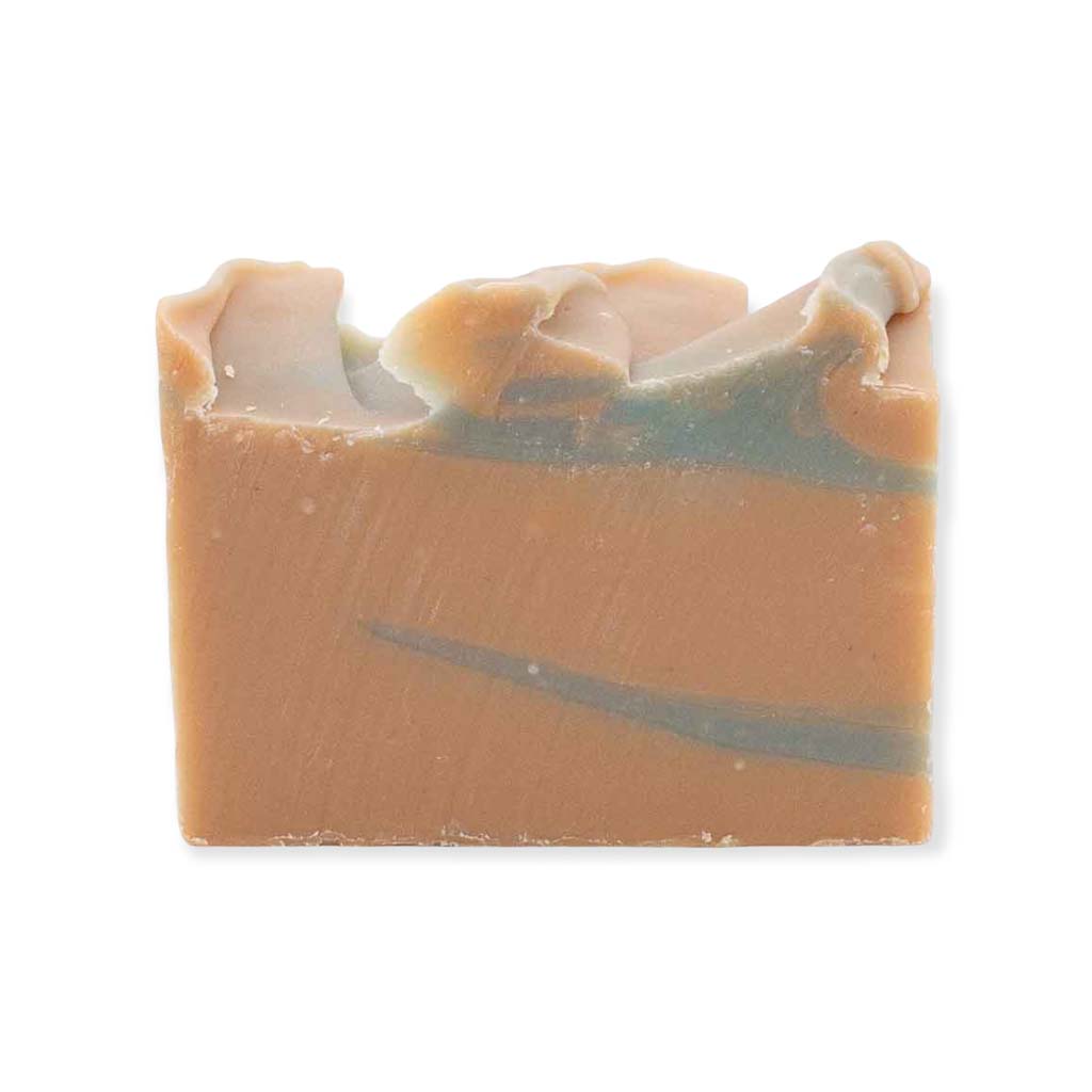 A brown and grey bar of Acadian Driftwood soap against a white background.